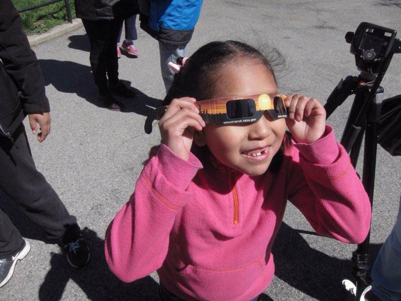 young astronomer with eclipse glasses